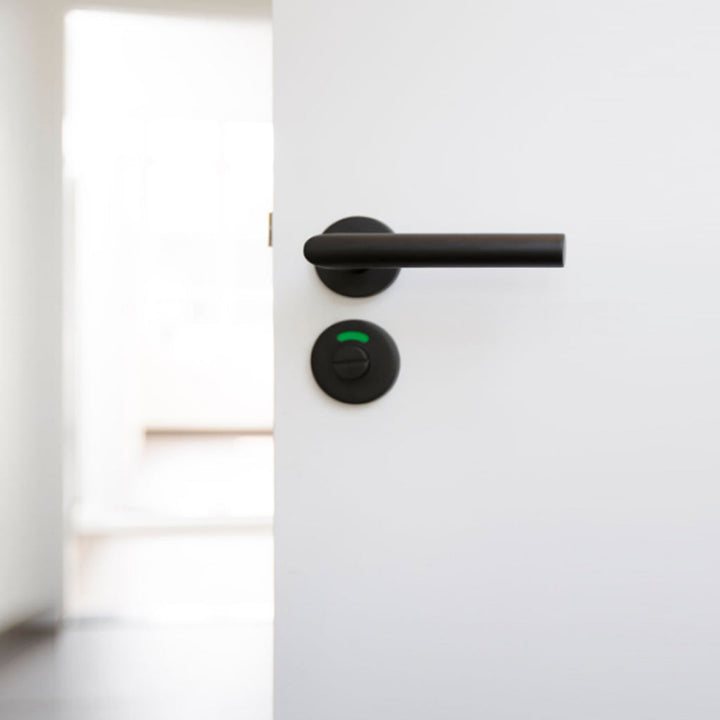 A Formani BASICS LBIII-19 Door Lever handle on a white door.