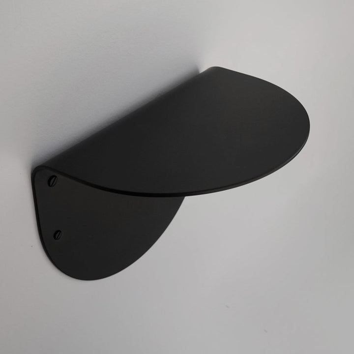 A black BENDE Shelf Ledge mounted to the side of a wall by CSSN.