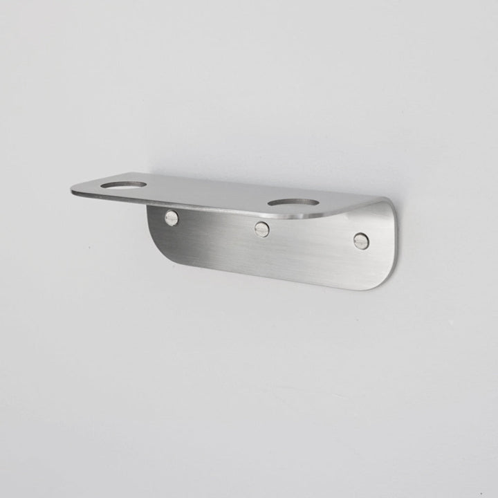 Bende Double Soap Holder in satin stainless steel mounted on white wall with 3 slot head screws