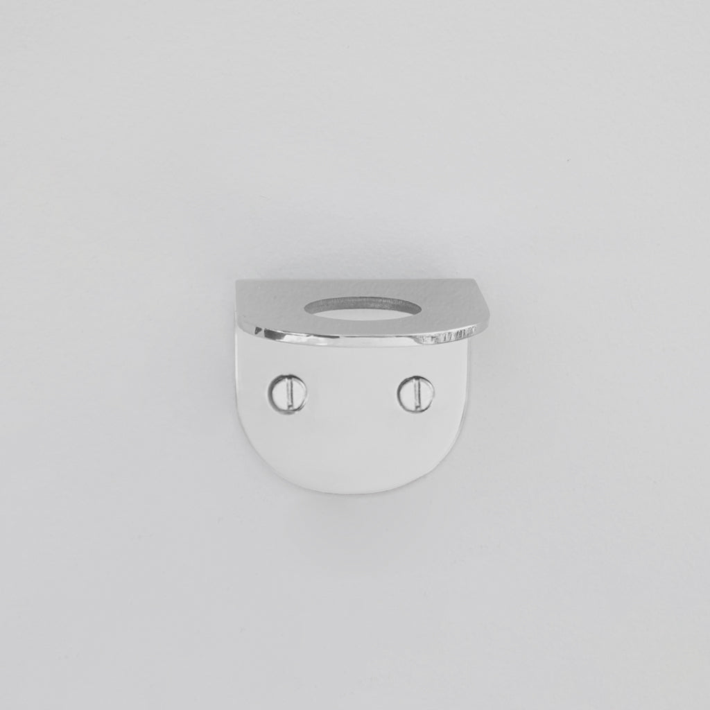 A CSSN BENDE Soap Holder Bracket Single with two eyes on a white wall.