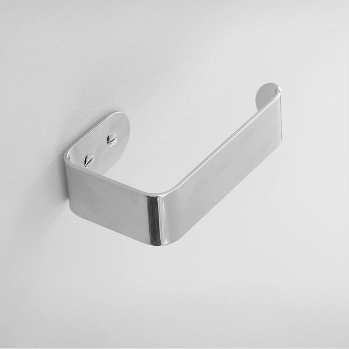 A close up of a CSSN BENDE Toilet Roll Holder on a wall.