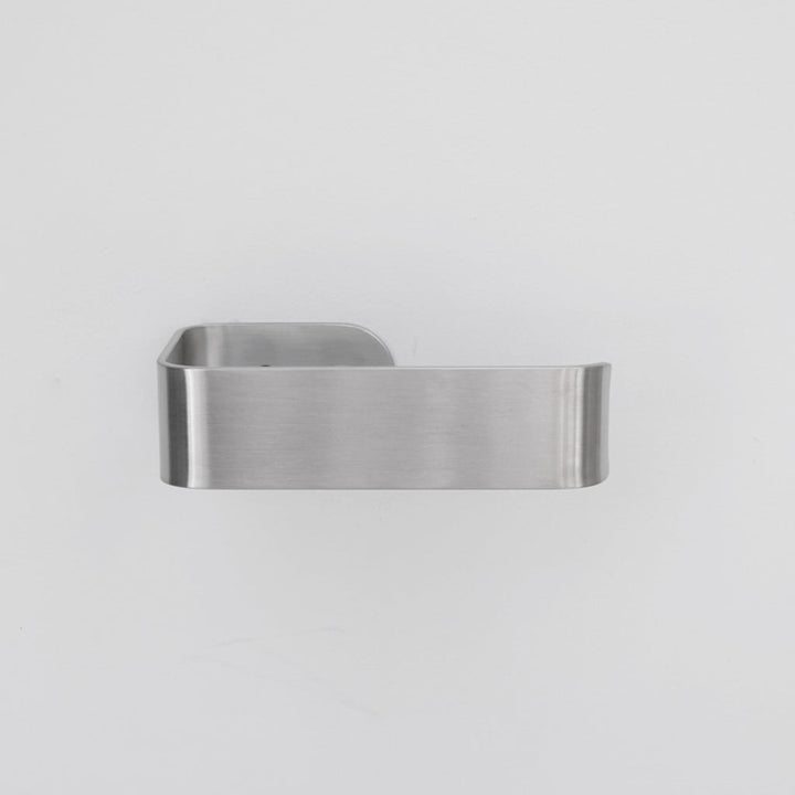 A close up of a CSSN BENDE Toilet Roll Holder on a wall.