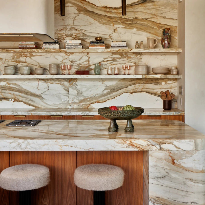 Modern kitchen with marble shelves and marble waterfall island and backsplash with flush Bocci22 outlets