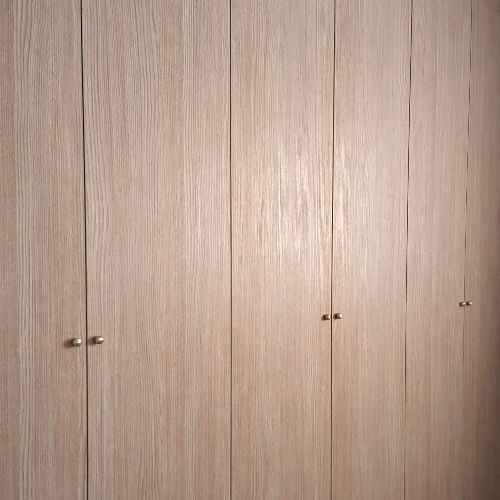 A wood wardrobe fitted with Maha Alavi Cercle knobs or pulls.