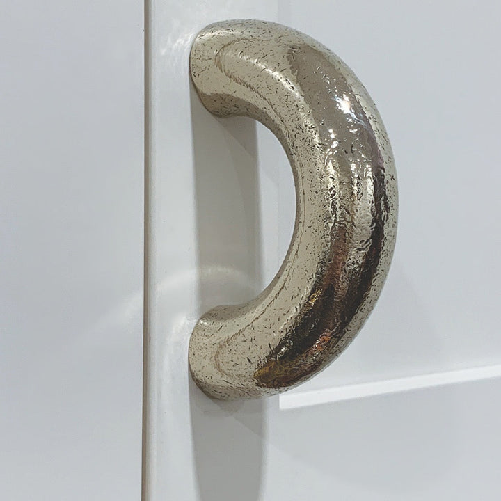 solid cast natural and white brass and bronze curved cabinet hardware handle by Maha Alavi