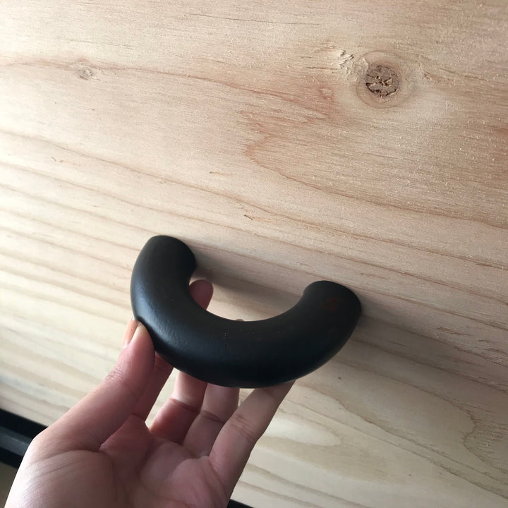 solid cast natural and white brass and bronze curved cabinet hardware handle by Maha Alavi