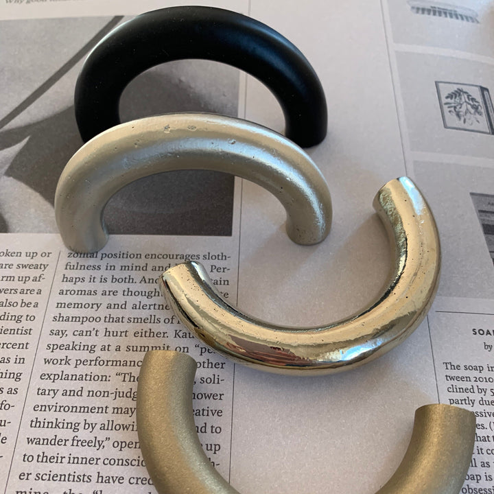 solid cast natural and white brass and bronze curved cabinet hardware handle by Maha Alavi