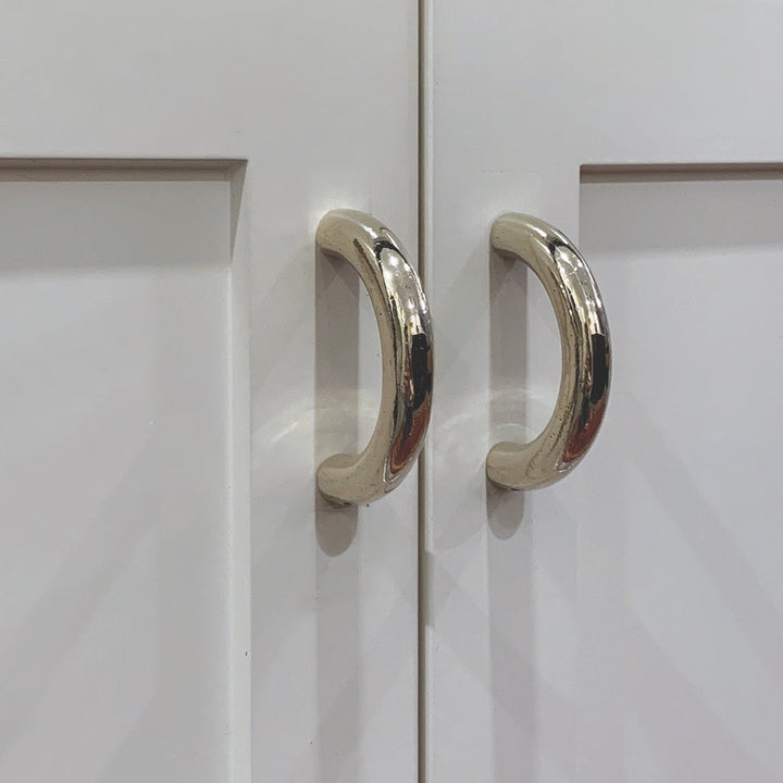 solid cast natural and white brass and bronze curved cabinet hardware handle by Maha Alavi