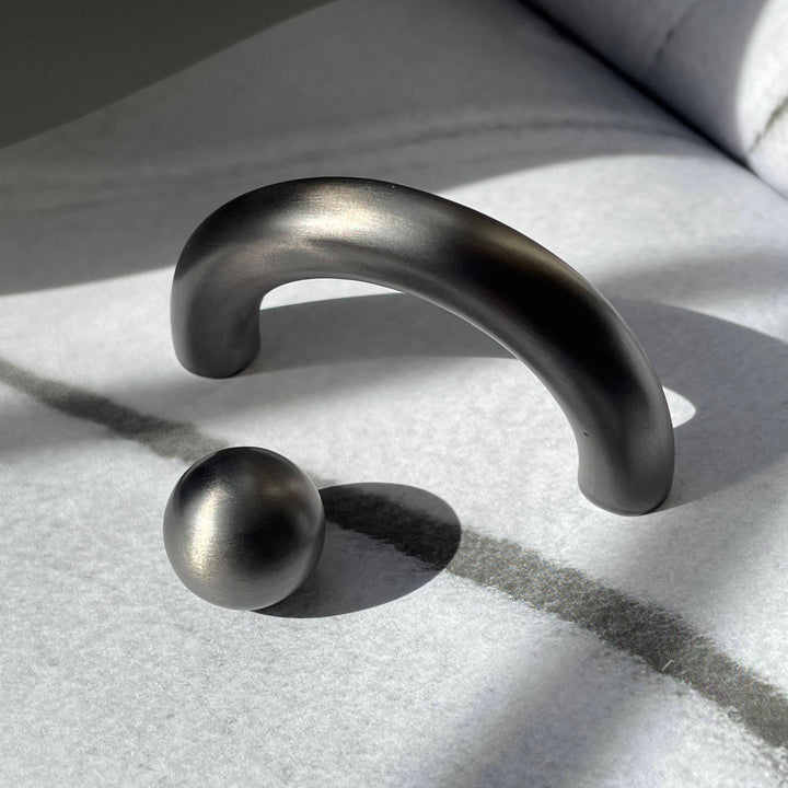 solid cast natural and white brass and bronze curved cabinet hardware handle by Maha Alavi