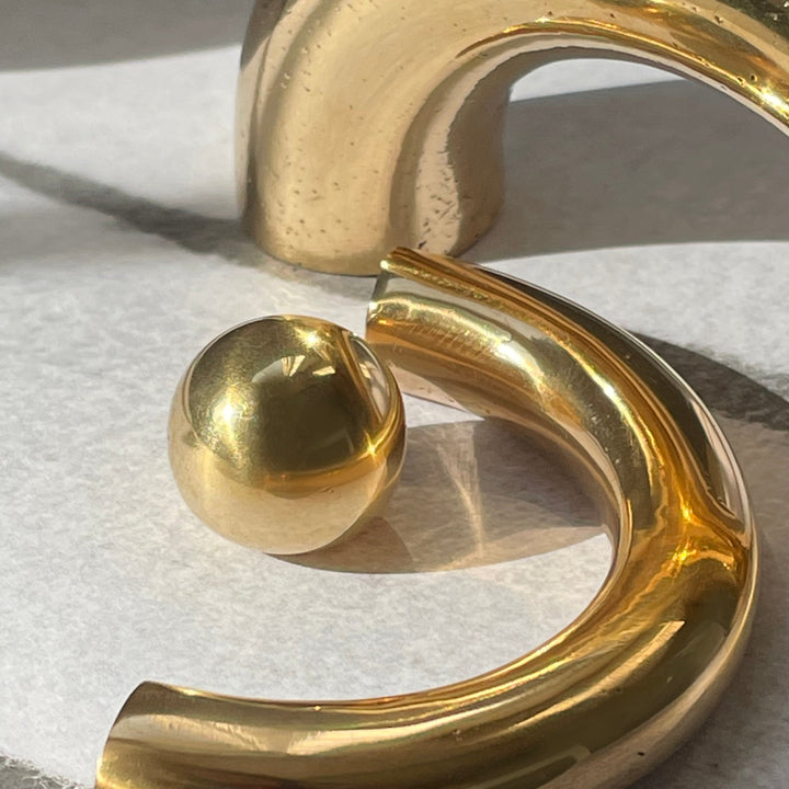 solid cast natural and white brass and bronze curved cabinet hardware handle by Maha Alavi