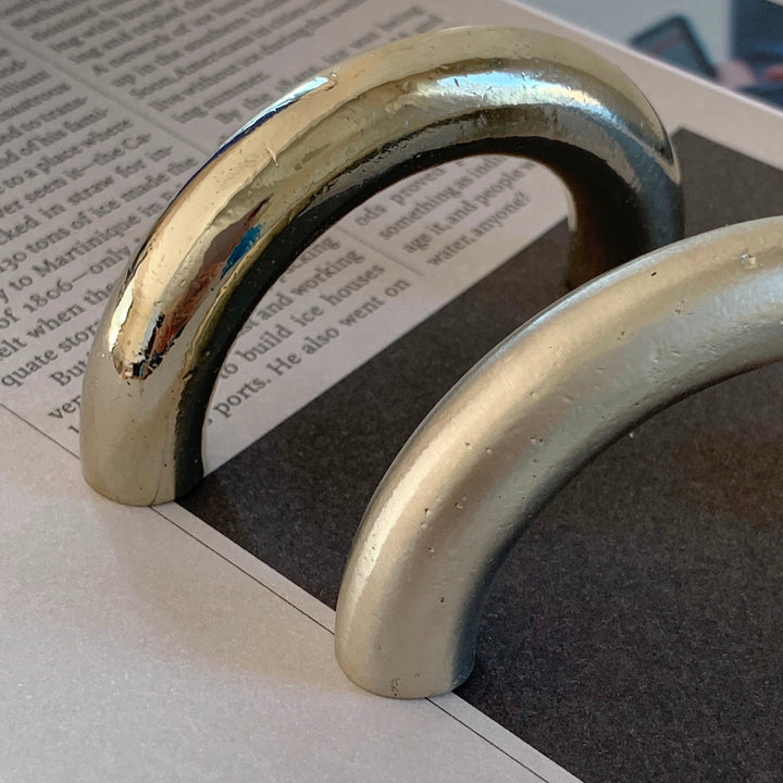 solid cast natural and white brass and bronze curved cabinet hardware handle by Maha Alavi