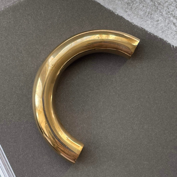 solid cast natural and white brass and bronze curved cabinet hardware handle by Maha Alavi