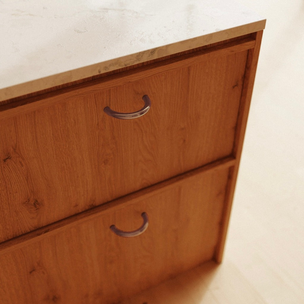 Brass Maha Alavi Cercle thin pulls on a wood cabinet.