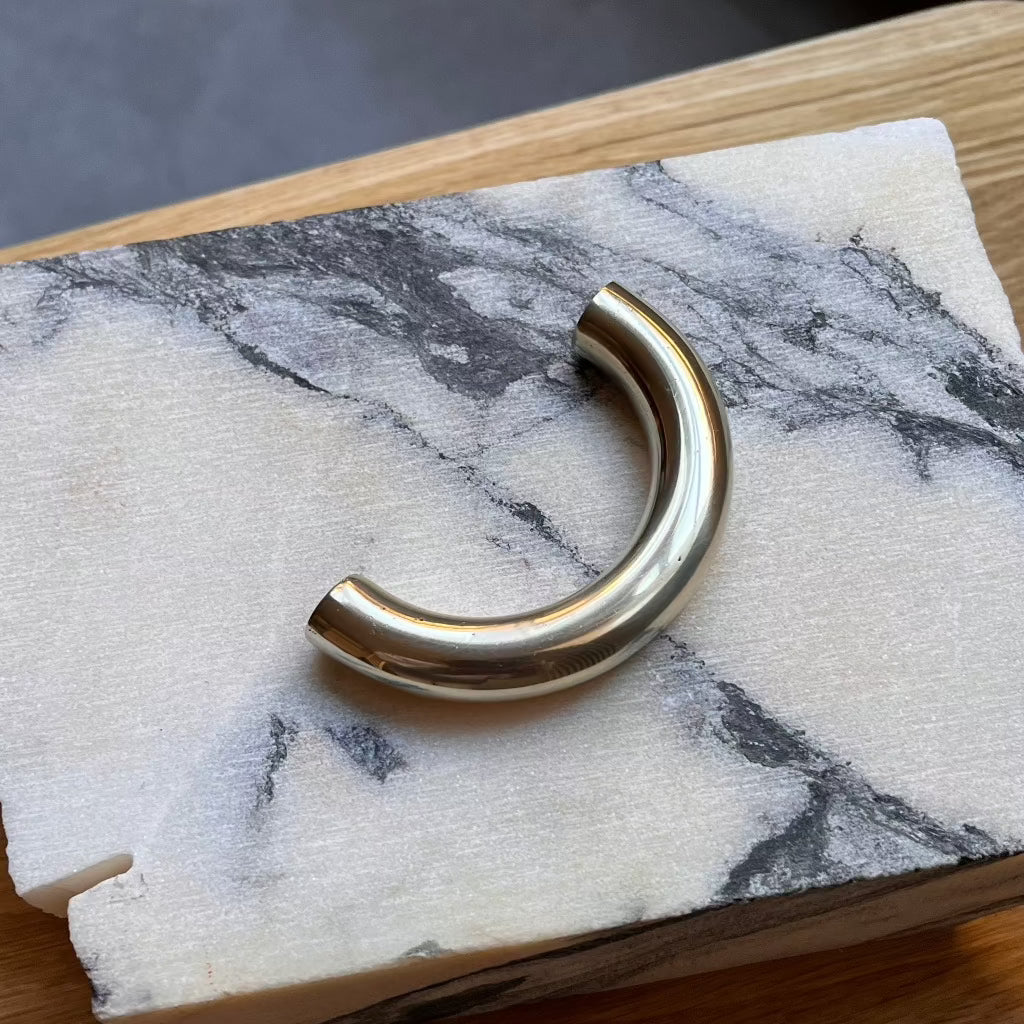 Brass Maha Alavi Cercle thin pull on marble.