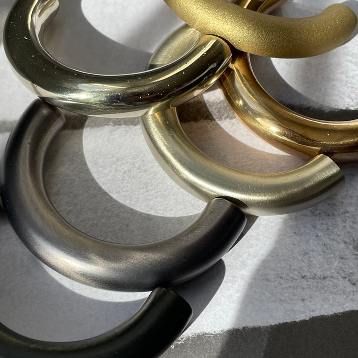 solid cast natural and white brass and bronze curved cabinet hardware handle by Maha Alavi