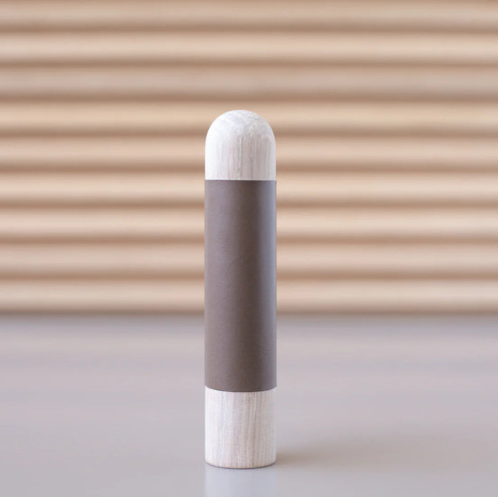 Chapman & Bose wood appliance bar pull with a ash body and a taupe leather half-leather wrap.