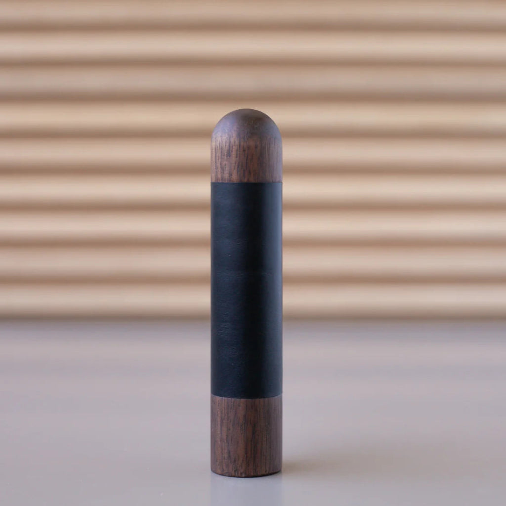 Chapman & Bose wood appliance bar pull with a walnut body and a navy leather half-leather wrap.