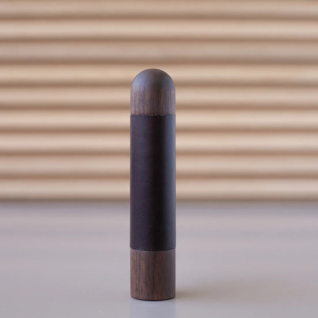 Chapman & Bose wood appliance bar pull with a walnut body and a aubergine leather half-leather wrap.