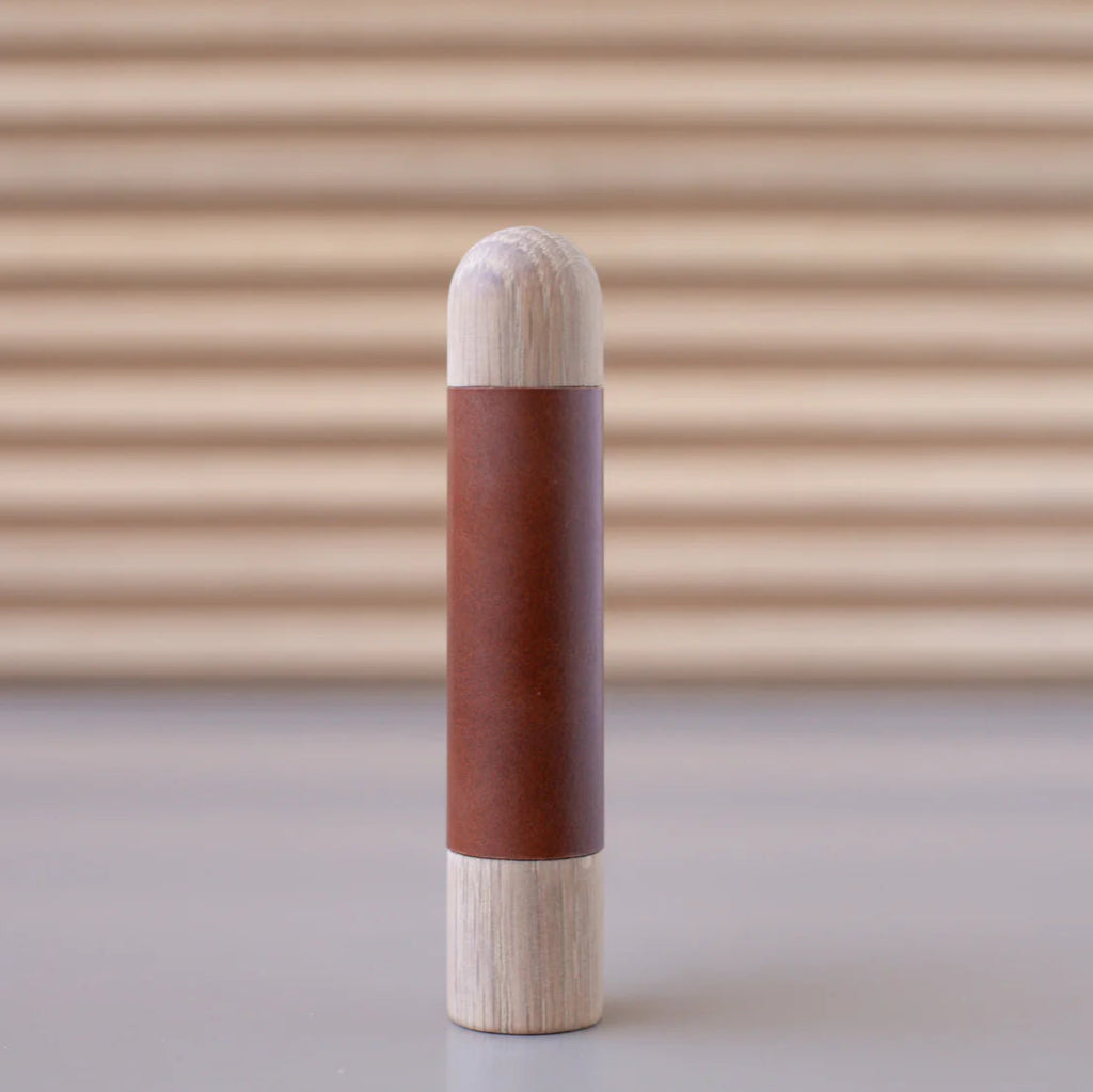 Chapman & Bose wood appliance bar pull with a oak body and a rust leather half-leather wrap.