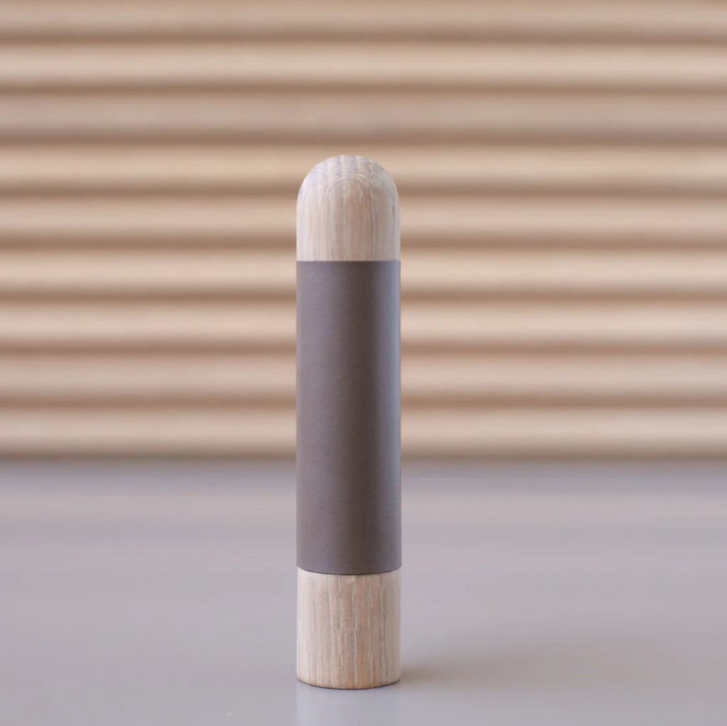 Chapman & Bose wood appliance bar pull with a oak body and a taupe leather half-leather wrap.