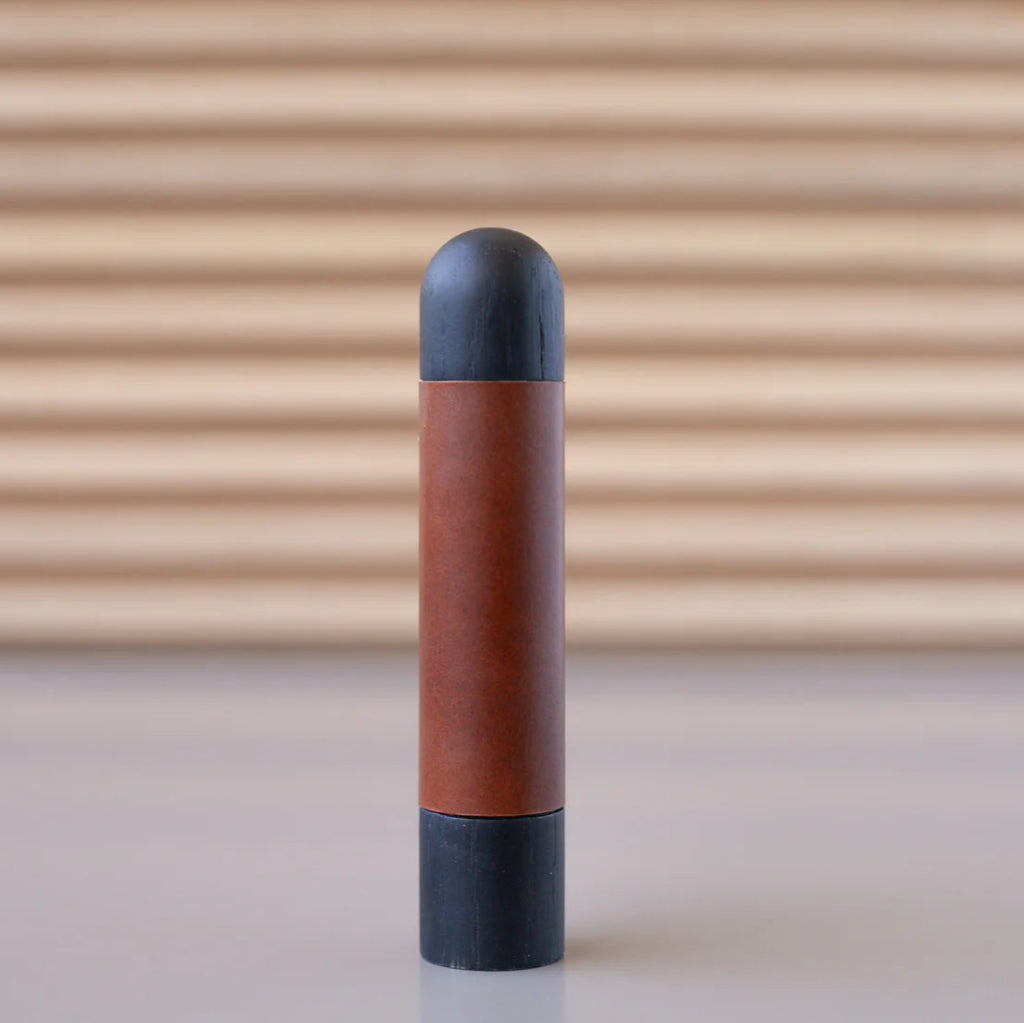 Chapman & Bose wood appliance bar pull with an oak body and a rust leather half-wrap.
