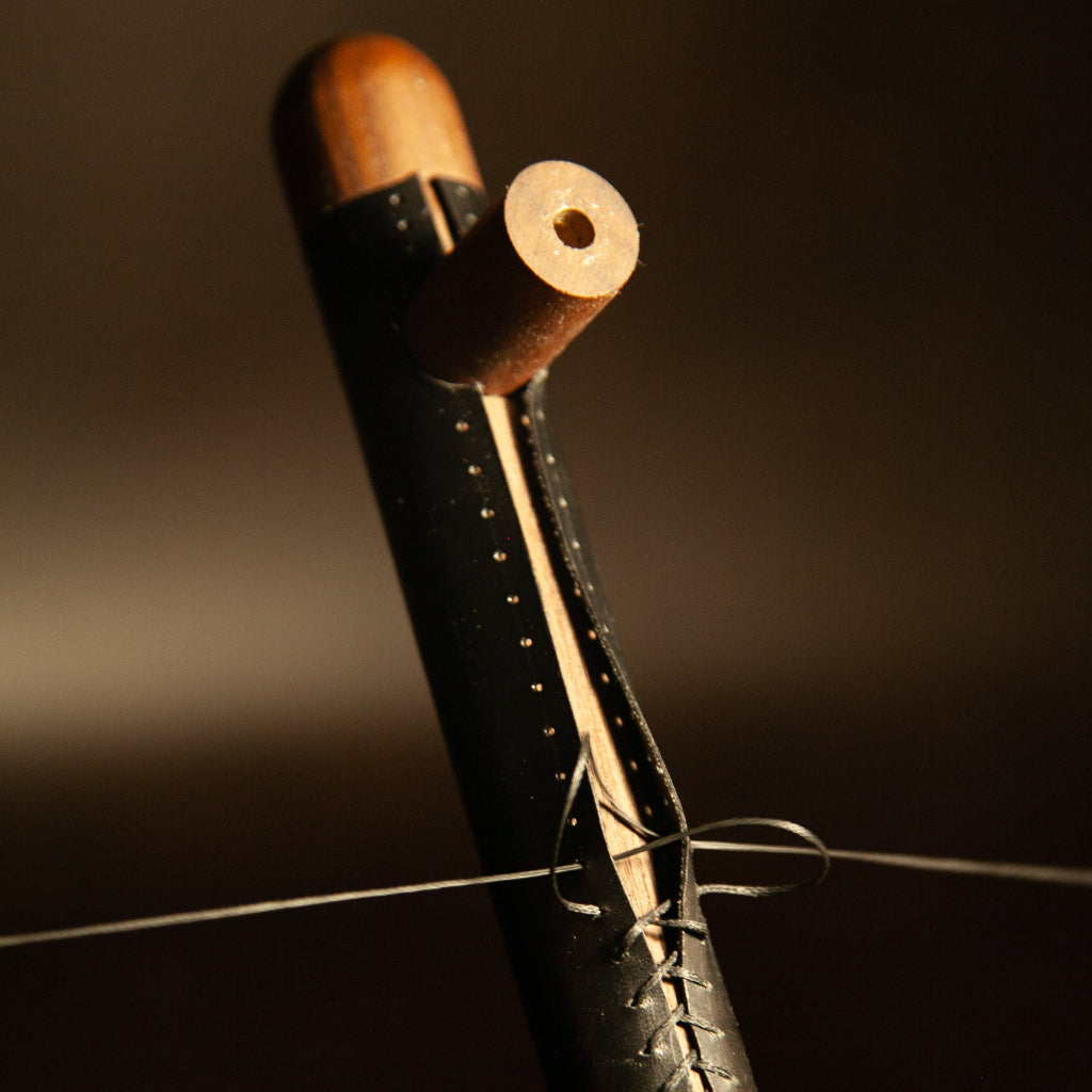 Close view of a Chapman & Bose leather-wrapped pull showing the stitching.