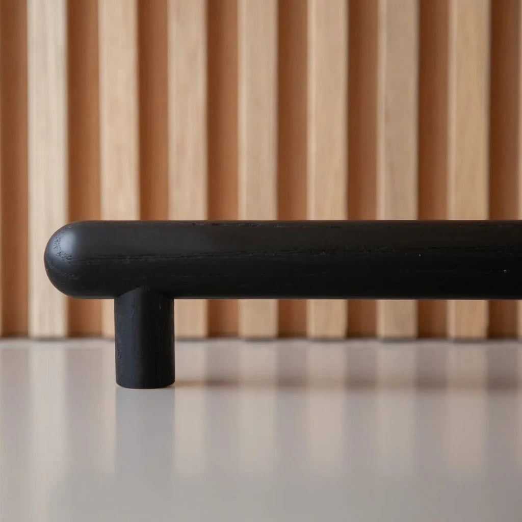 Blackened wood Chapman & Bose bar pull, a turned round bar on two posts.