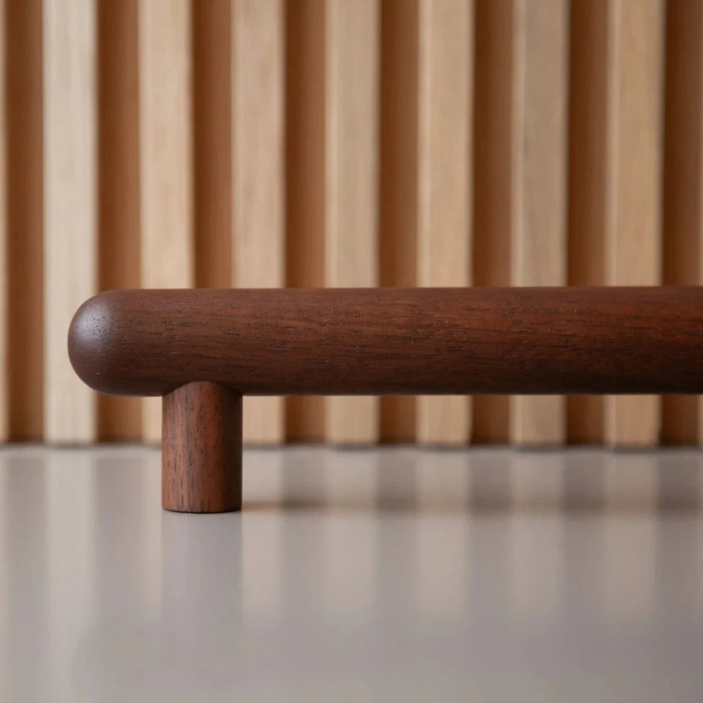 Walnut wood Chapman & Bose bar pull, a turned round bar on two posts.