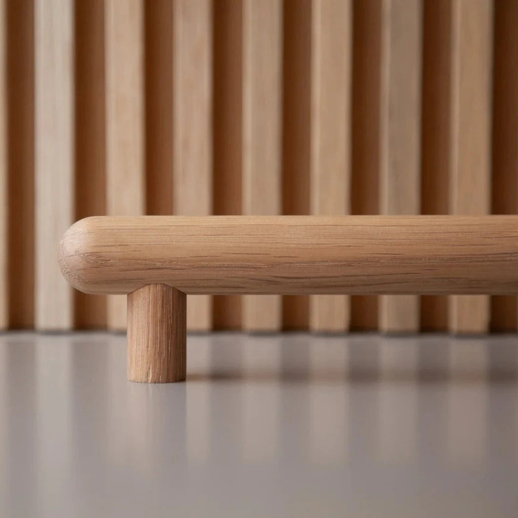 White oak wood Chapman & Bose bar pull, a turned round bar on two posts.