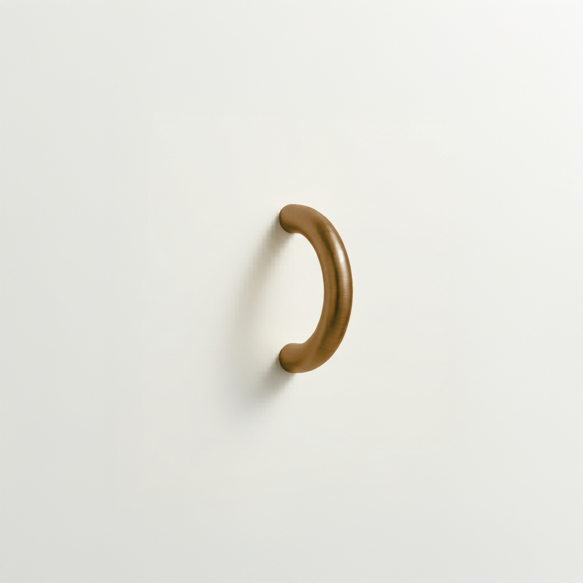 Antique bronze Charlie Arc pull, a small half-round arc handle, mounted on a white surface.