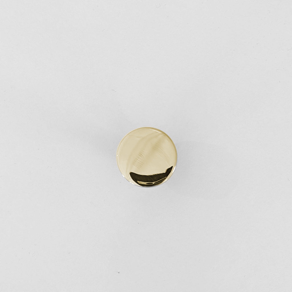 A small round Charlie Chunky Knob by CBH on a white surface.
