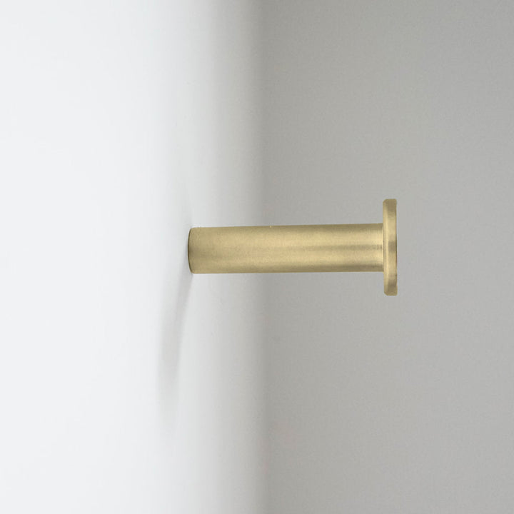 A close up of a CBH Charlie Nail Hook on a white wall.