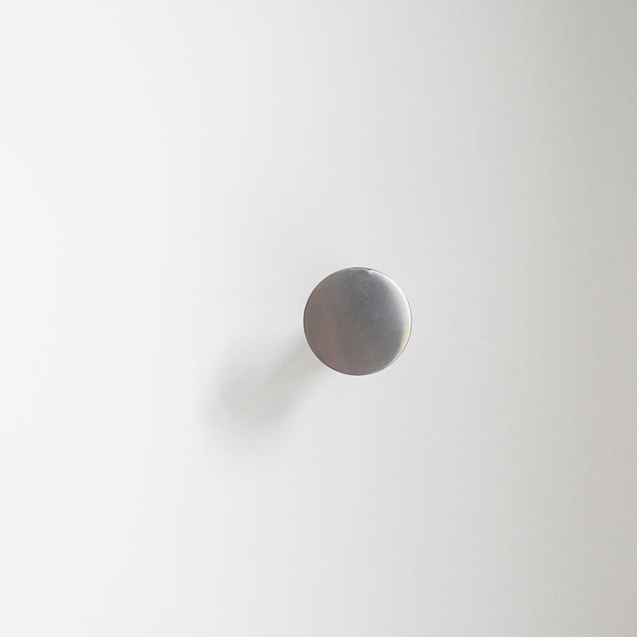 A white wall with a CBH Charlie Nail Hook on it.