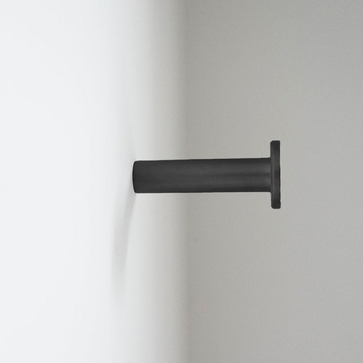 A CBH Charlie Nail Hook on a white wall.