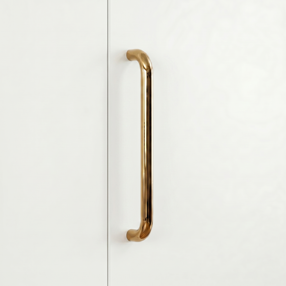 Polished brass Charlie Radius cabinet and appliance pull, a D-shaped tubular handle with radiused corners, mounted vertically on cabinetry.