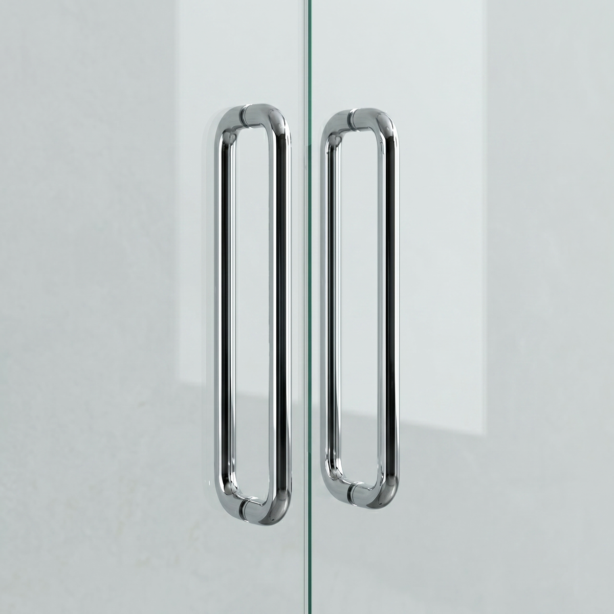 Polished chrome Charlie Radius door pull, a D-shaped tubular handle with softly radiused corners, mounted back-to-back on a glass door.