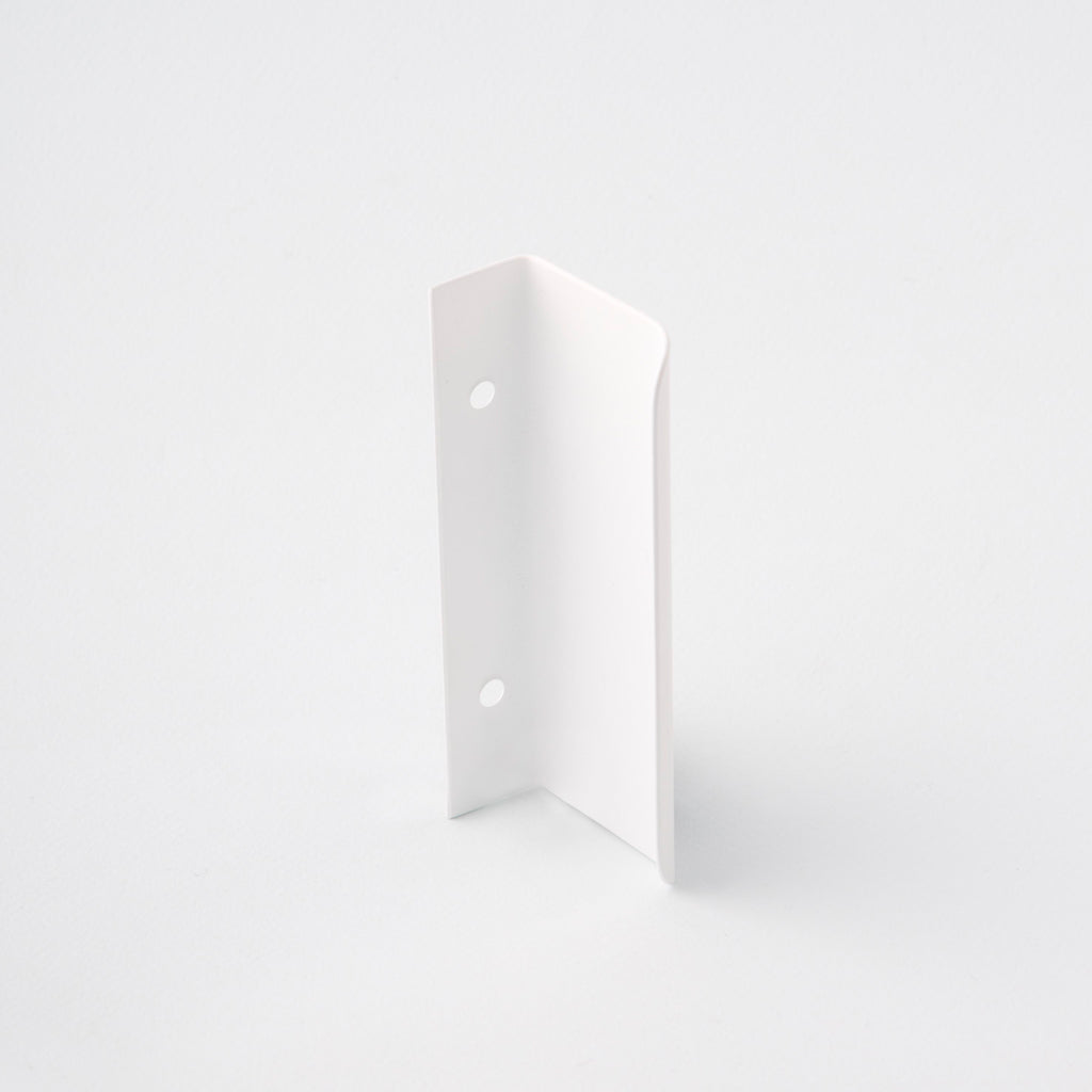 Short white tab pull for cabinets. Simple and minimal hardware. Made in Toronto. From the back.