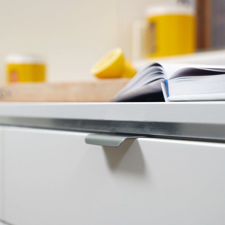 A close-up of a drawer with a CBH Charlie Tab Small book on it.