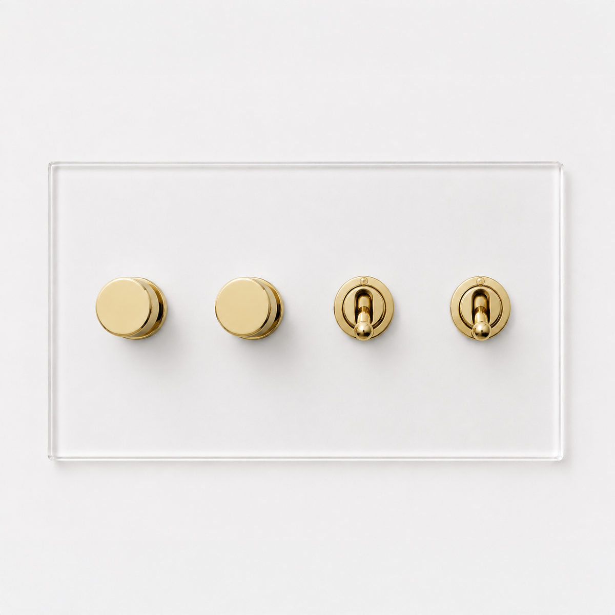 Forbes & Lomax Invisible plate with two brass rotary dimmers and two brass toggle switches on a clear acrylic base.