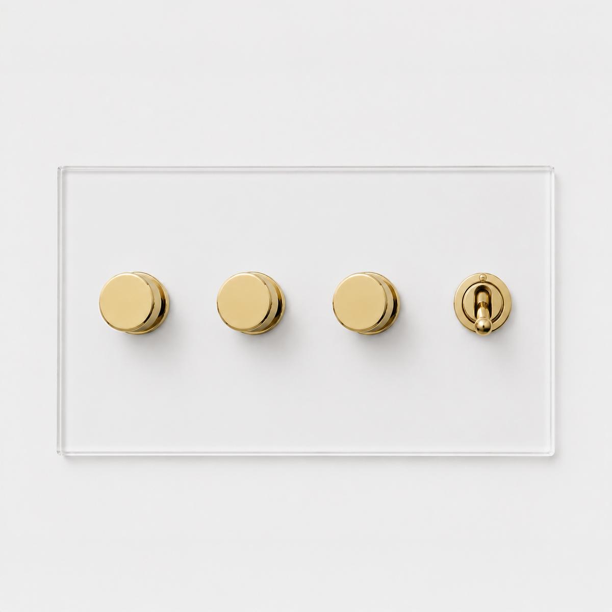 Forbes & Lomax transparent acrylic plate with three brass rotary dimmers and one brass toggle switch.