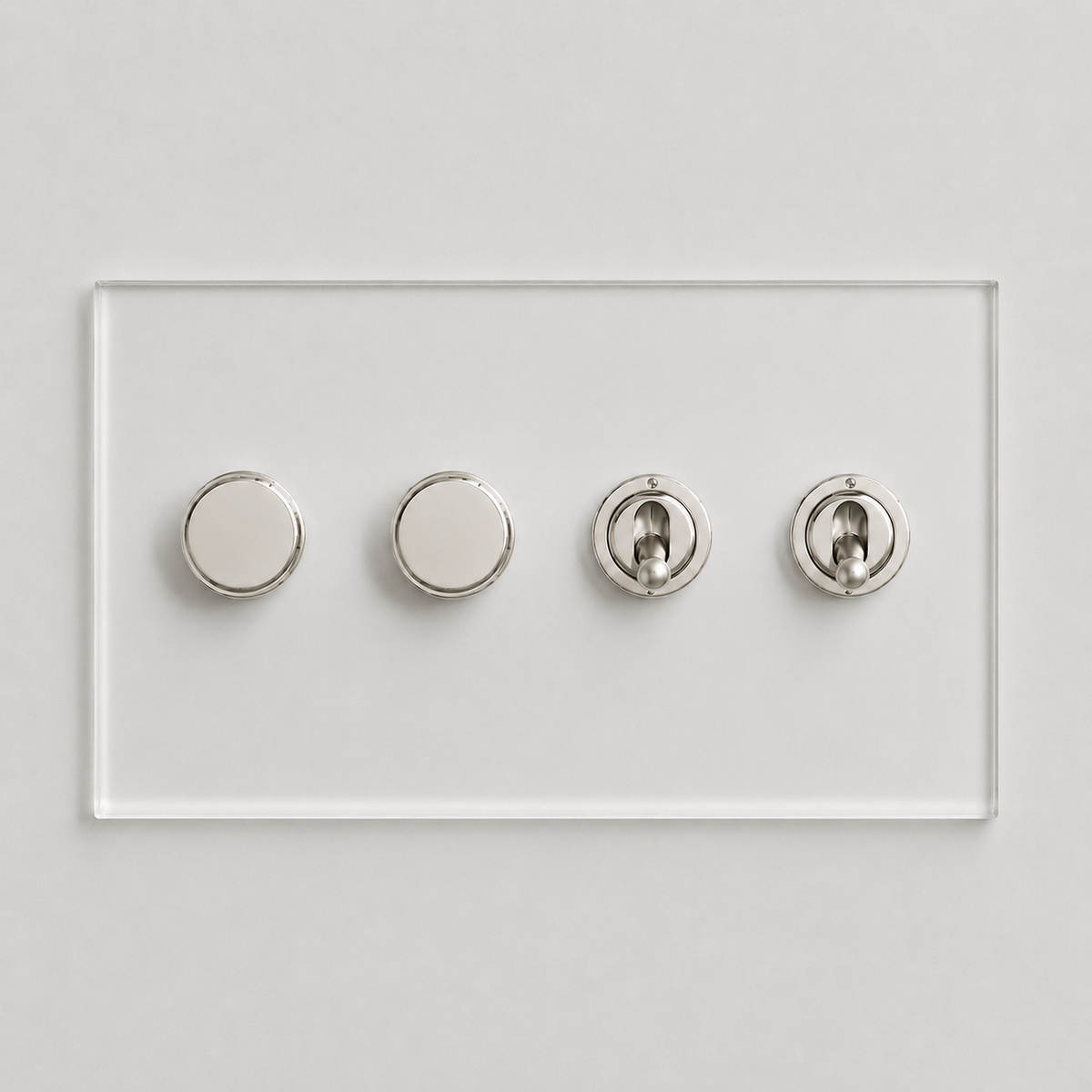 Forbes & Lomax Invisible plate with two nickel rotary dimmers and two nickel toggle switches on a clear acrylic base.