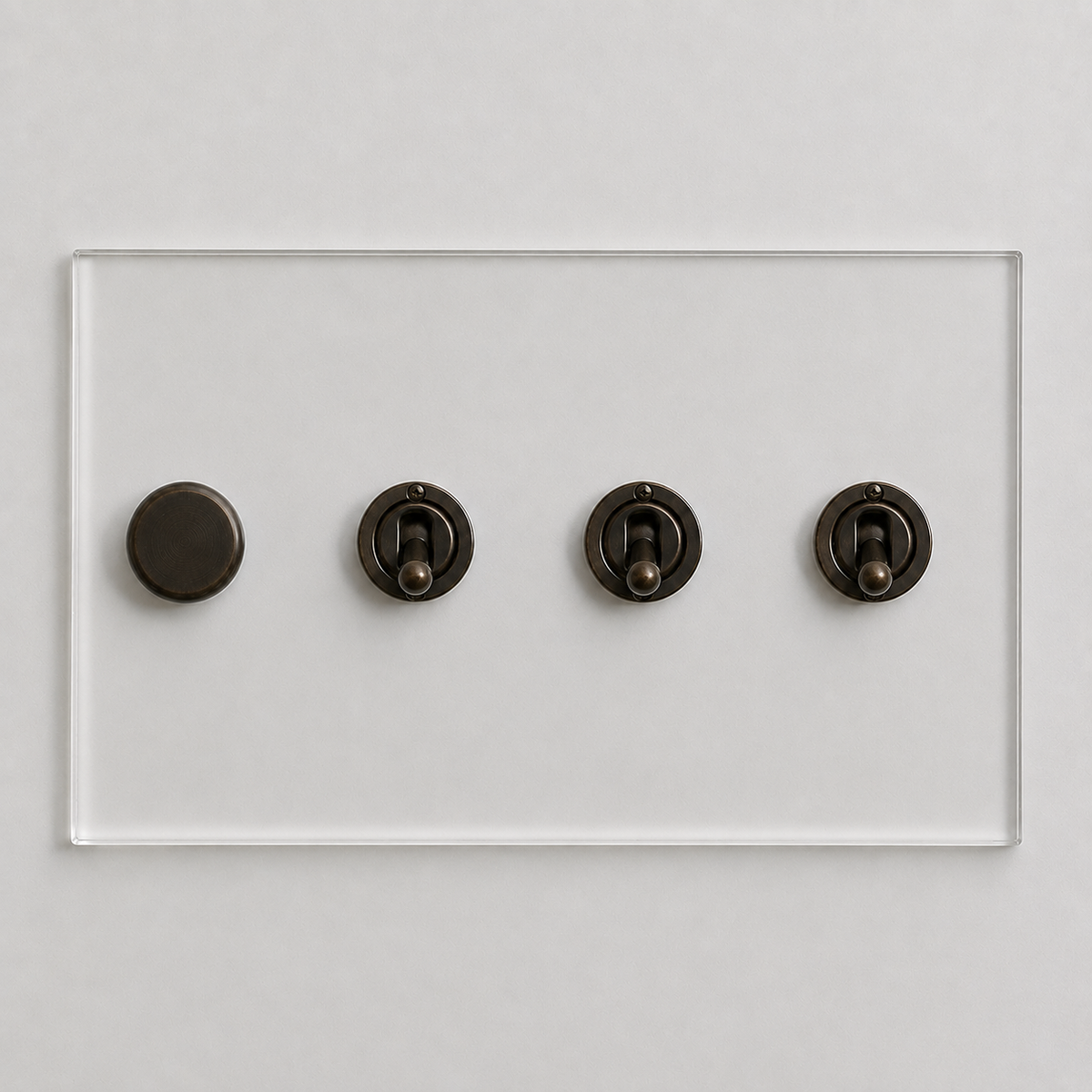 Forbes & Lomax Invisible plate with one antique bronze rotary dimmer and three matching toggle switches on clear acrylic.