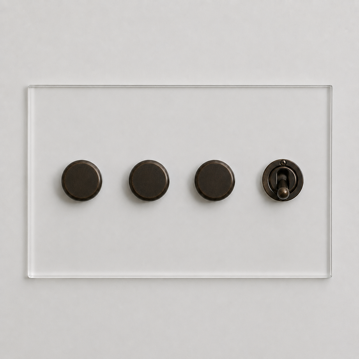 Forbes & Lomax transparent acrylic plate with three bronze rotary dimmers and one matching bronze toggle switch.