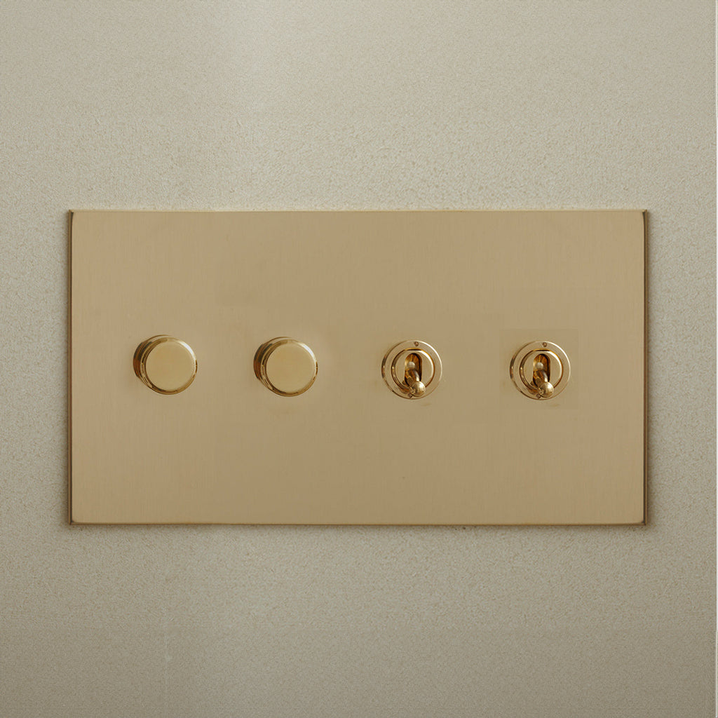 Brass Forbes & Lomax switch plate with two dimmers and two toggles.