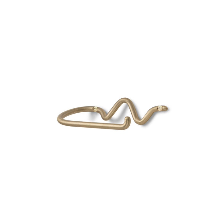 a Ferm Living Curvature Toilet Roll Holder with a curved design on it.