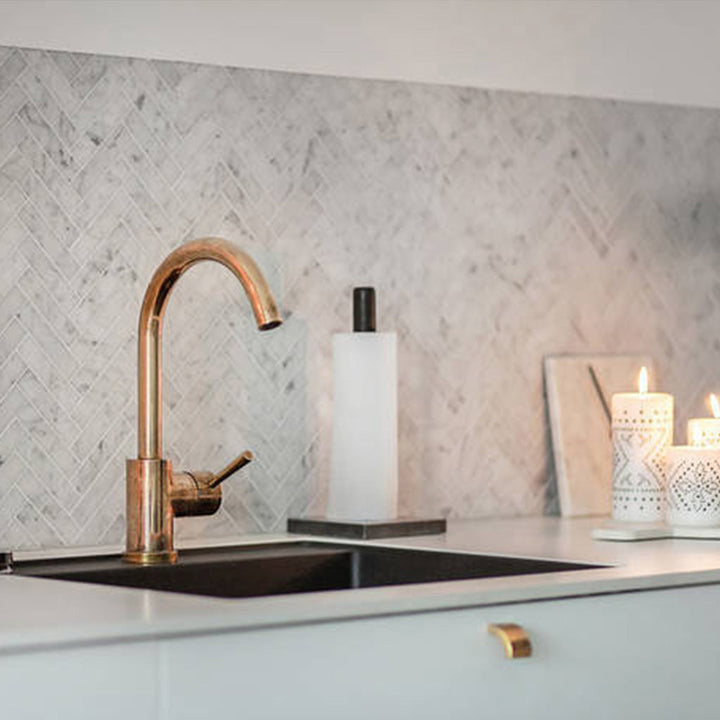 Brass curve handle and knob on modern cabinets.