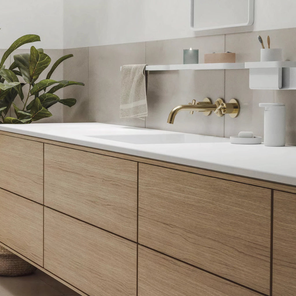 Bathroom sink with light wood cabinetry below