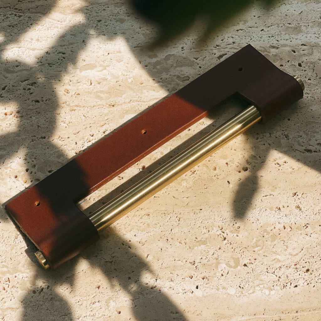 Tan leather Chapman & Bose EP03 edge pull shown on a stone surface.