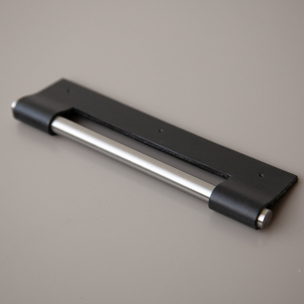 Black Chapman & Bose EP03 leather edge pull with a stainless steel core, wrapped over the drawer edge.