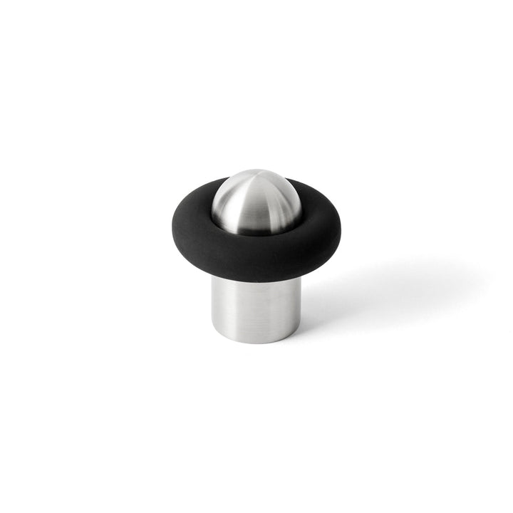 FAT Satin Stainless Steel Door Stop, stood on white background. Designed by Tom Dixon for d line.